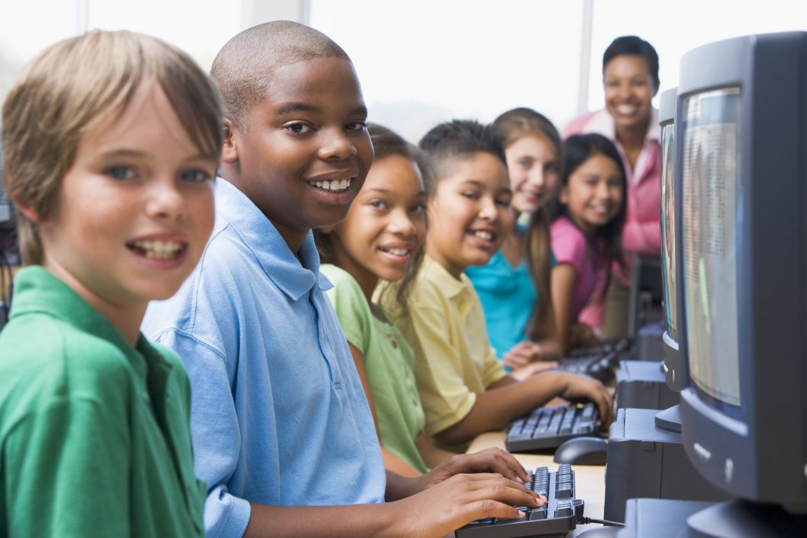 group of kids on computers in class